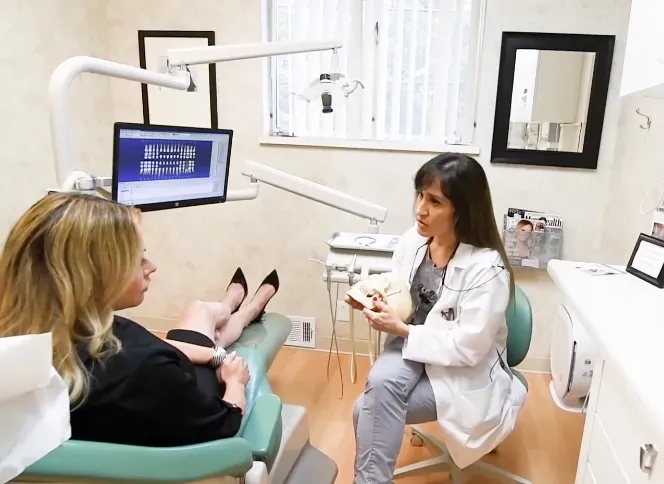 Dr. Rivero consulting with a patient at Smile Art Dental Studio